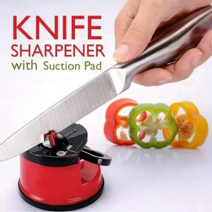 Knife sharpener with suction pad being used on a white background with sliced bell peppers.