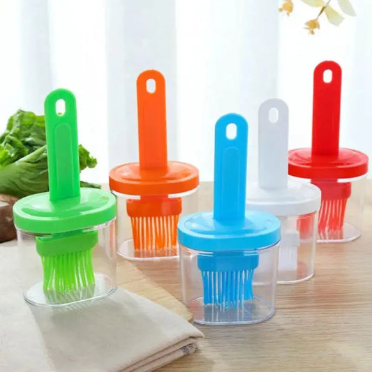 Set of colorful kitchen brushes with transparent handles on a wooden surface.